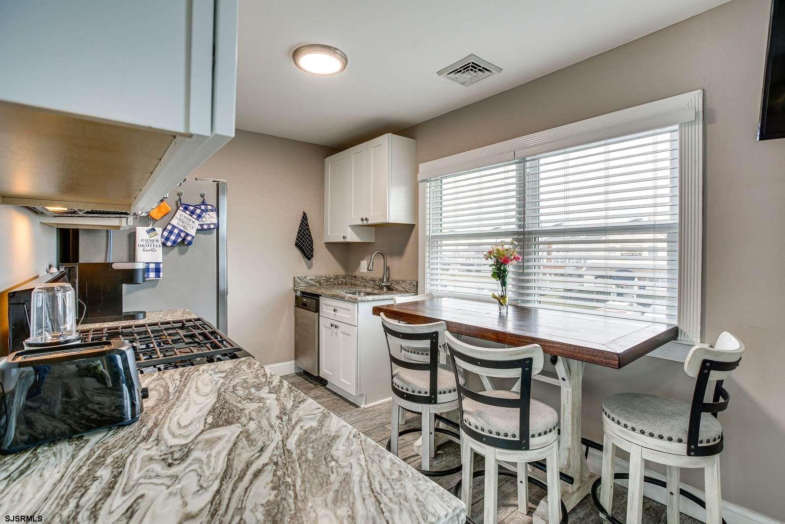 210 34th Street South, Unit 2 Brigantine, NJ 08203 - Photo 5 of 32 a kitchen with a table and chairs in it