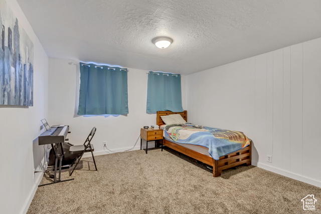 360 East Center Street Centerville, UT 84014 - Photo 28 of 41 Carpeted bedroom featuring a textured ceiling and baseboards