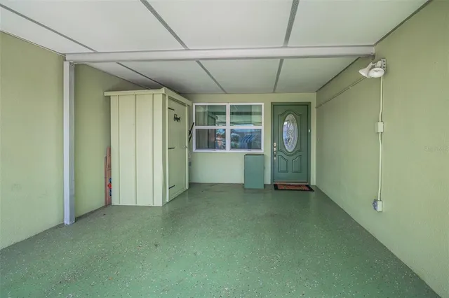 an empty room with closet and windows