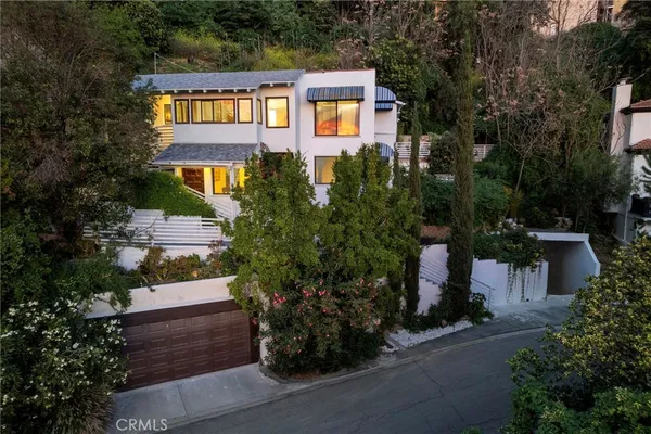a aerial view of a house with a yard and potted plants