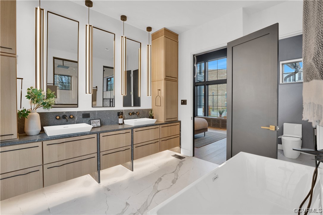 3501 Ormiston Grove Circle Henrico, VA 23233 - Photo 39 of 48 a large bedroom with a large bed and a chandelier