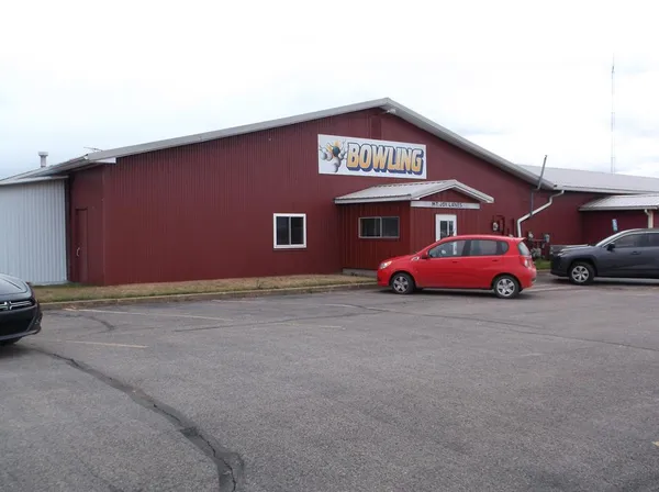 a variety of cars parked in front of a building
