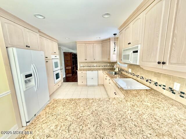a large white kitchen with granite countertop a refrigerator and a sink