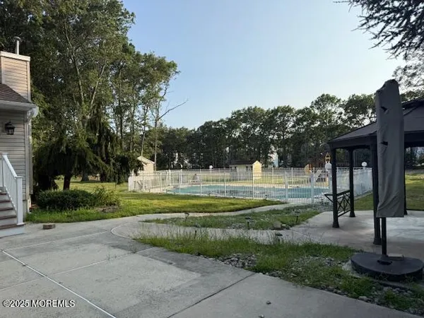 a swimming pool with outdoor seating and yard
