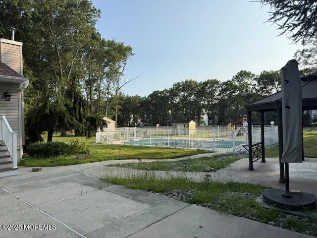 a swimming pool with outdoor seating and yard