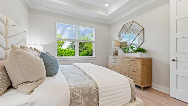 a bedroom with a bed and a mirror on dresser