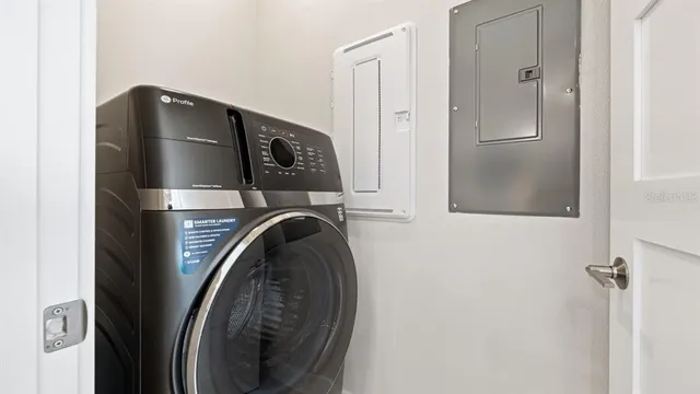 a living room with furniture a rug and a painting