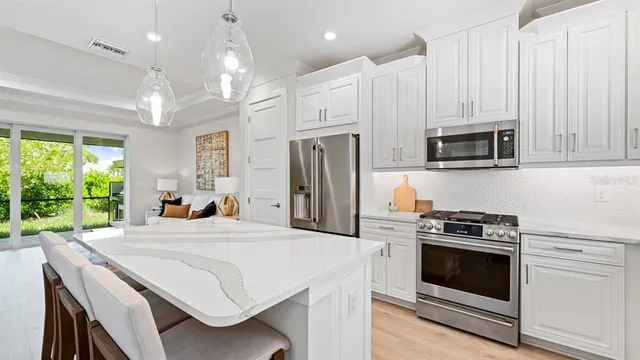a kitchen that has a stove a microwave and a refrigerator