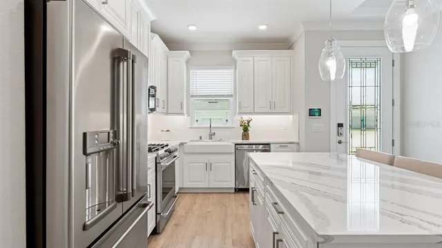 a kitchen with a sink stove and refrigerator