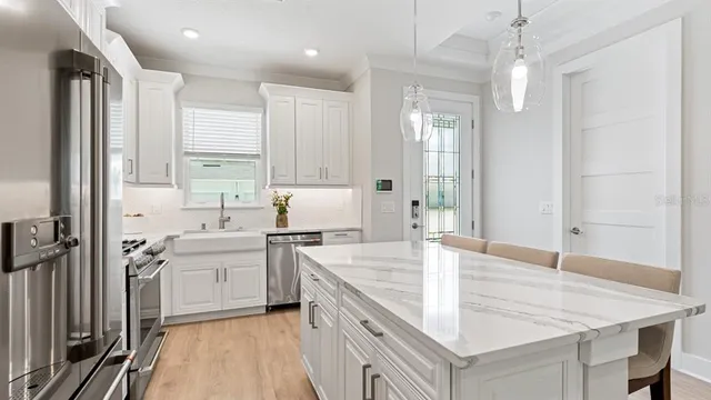 a kitchen with white cabinets and white appliances
