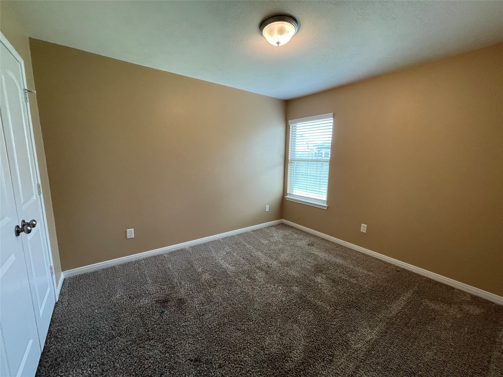 832 Mockingbird Street Navasota, TX 77868 - Photo 16 of 20 an empty room with windows