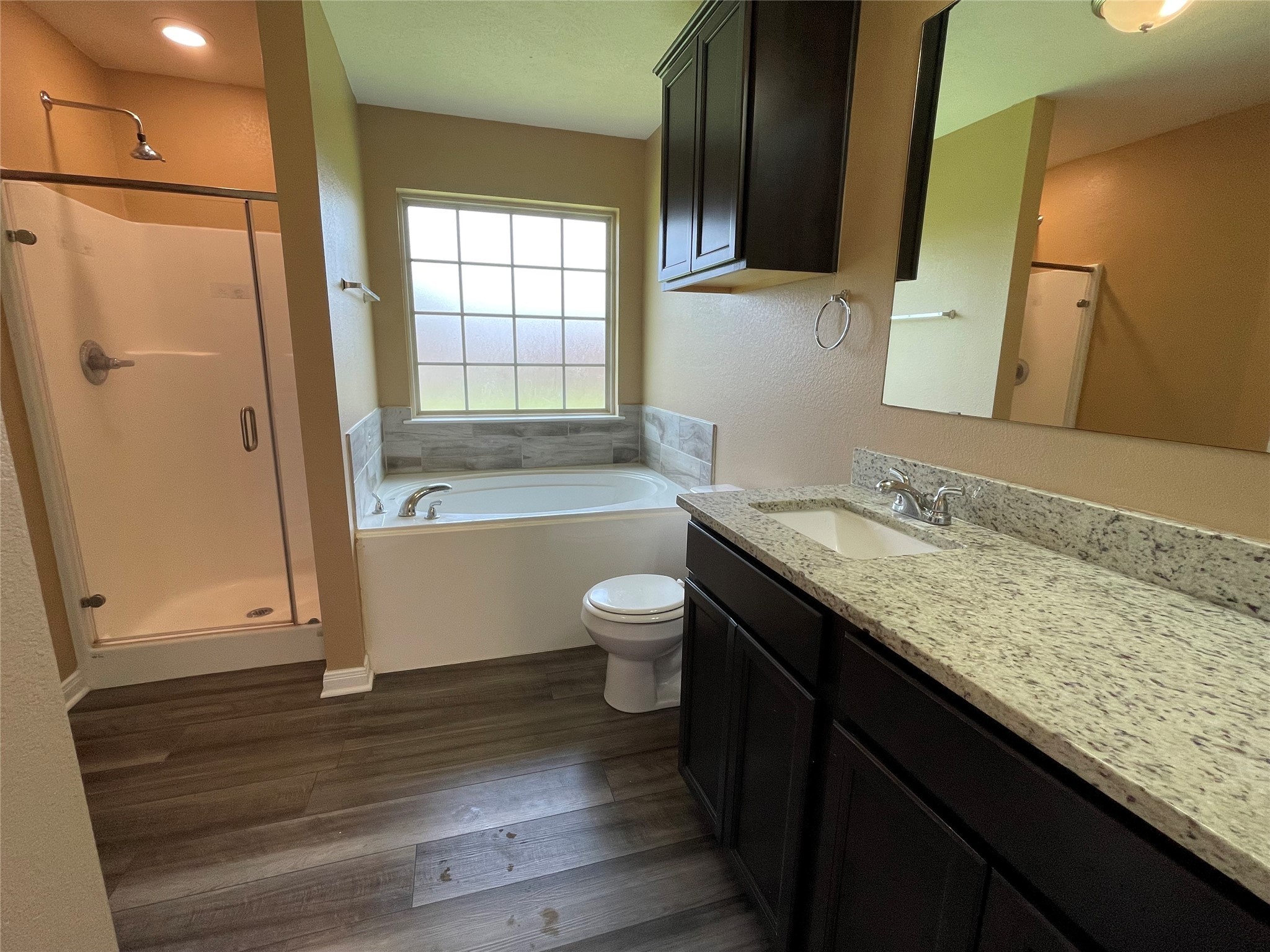 832 Mockingbird Street Navasota, TX 77868 - Photo 10 of 20 a bathroom with a granite countertop sink toilet and shower