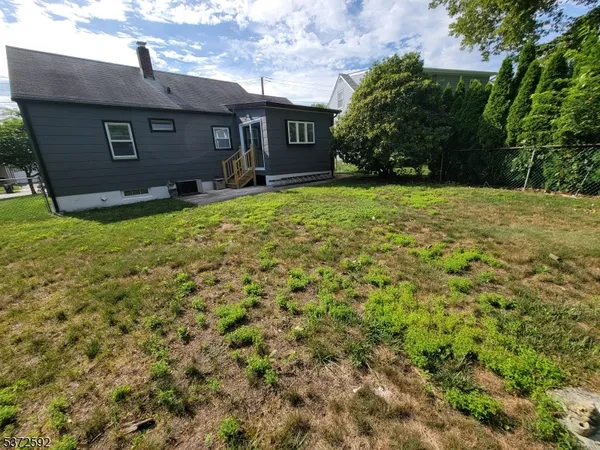 a front view of house with yard and trees