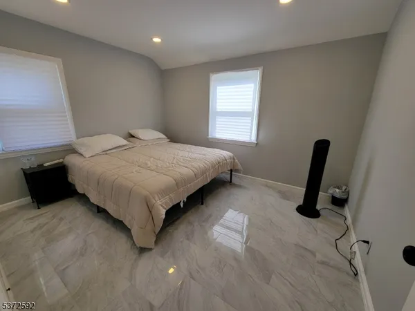 a bedroom with a bed and a chair