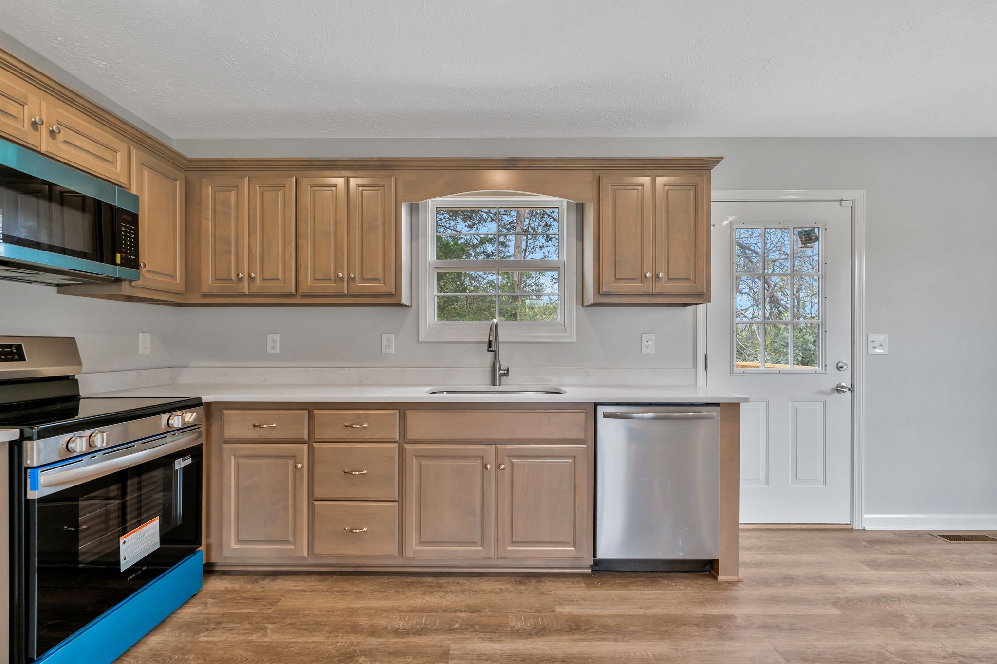 401 Doak Road, Unit 41 Manchester, TN 37355 - Photo 11 of 29 a kitchen with stainless steel appliances granite countertop a stove a sink and a microwave