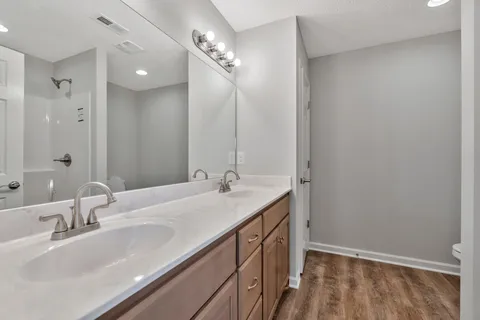 a bathroom with a double vanity sink and a mirror