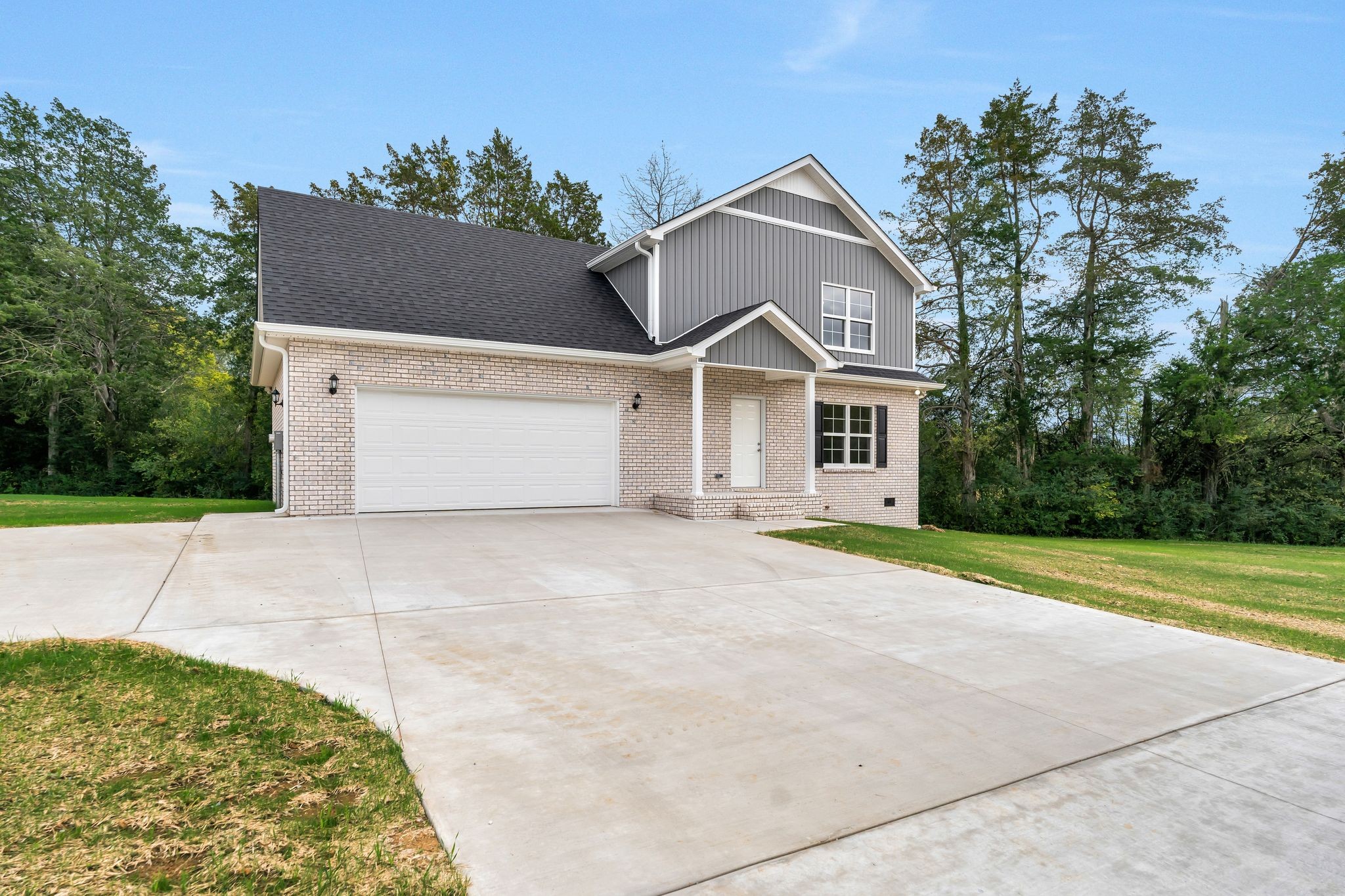 401 Doak Road, Unit 41 Manchester, TN 37355 - Photo 3 of 29 a front view of a house with a yard and garage