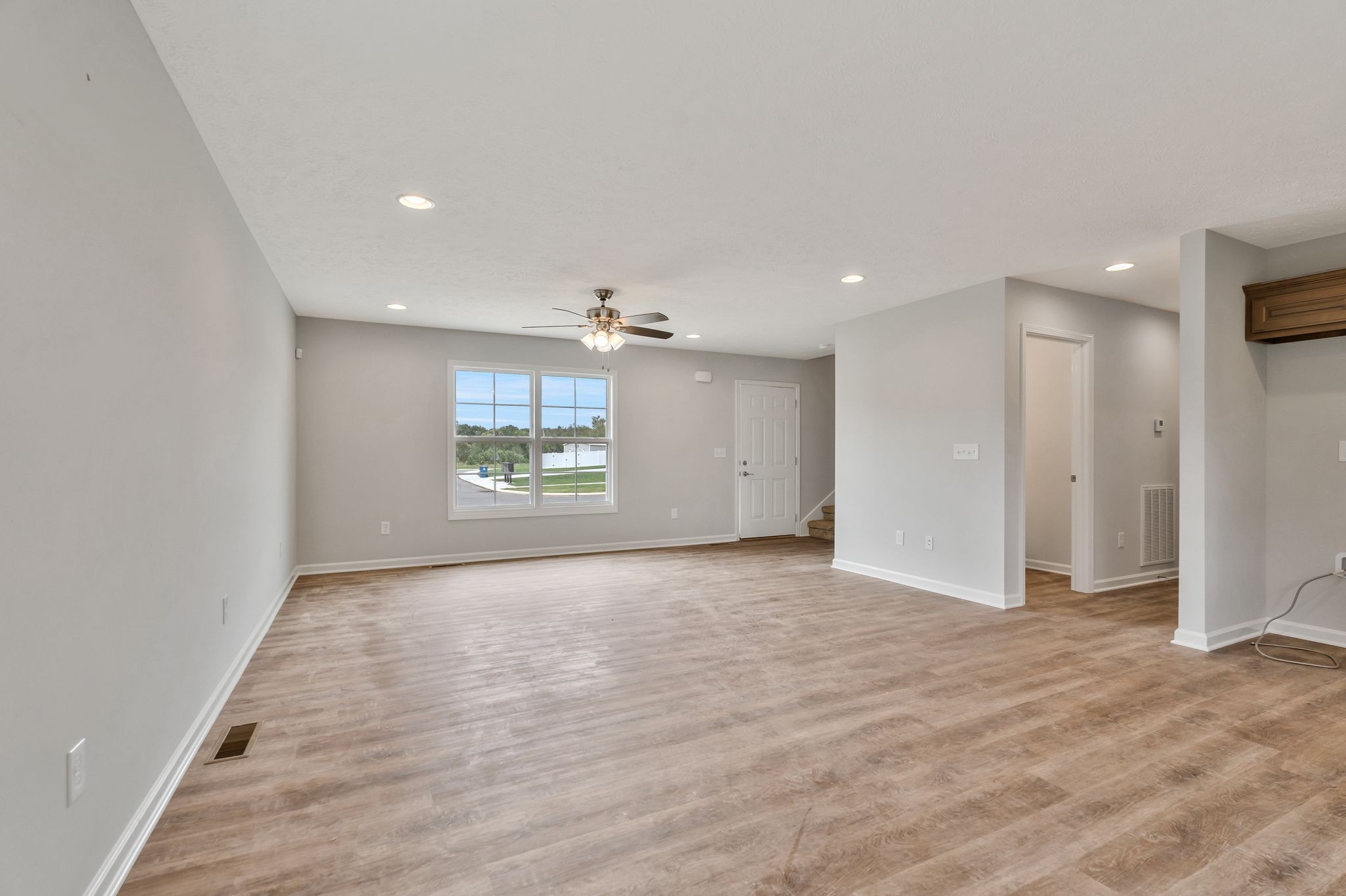 401 Doak Road, Unit 41 Manchester, TN 37355 - Photo 6 of 29 an empty room with wooden floor cabinet and windows