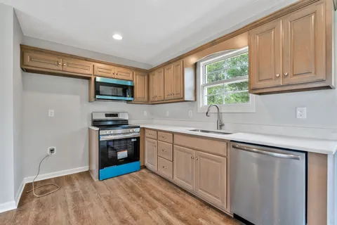 a kitchen with appliances cabinets and a sink