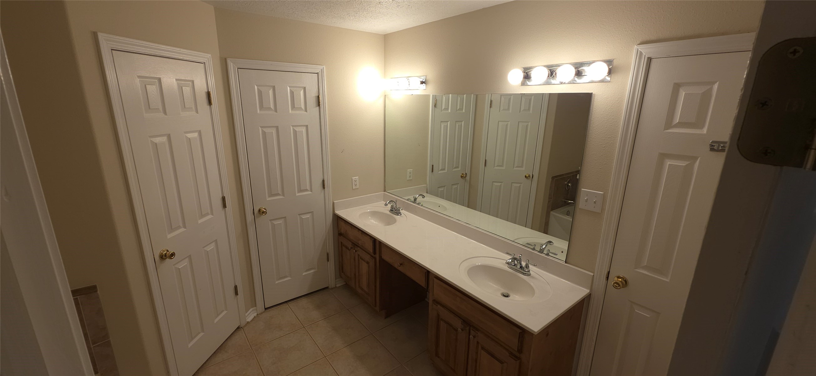 215 Bridgeview Drive Onalaska, TX 77360 - Photo 15 of 29 a bathroom with a sink a mirror and a shower
