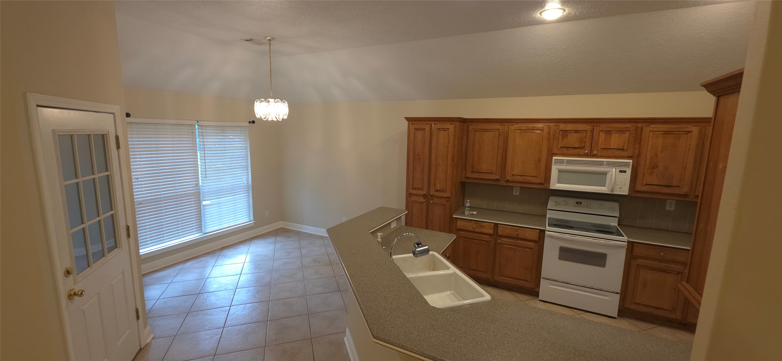 215 Bridgeview Drive Onalaska, TX 77360 - Photo 6 of 29 a kitchen with a refrigerator and cabinets