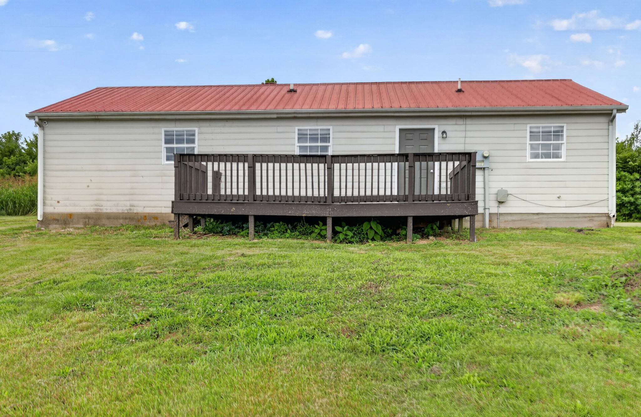 120 Driver Road Lafayette, TN 37083 - Photo 27 of 39 a view of a house with a backyard and deck