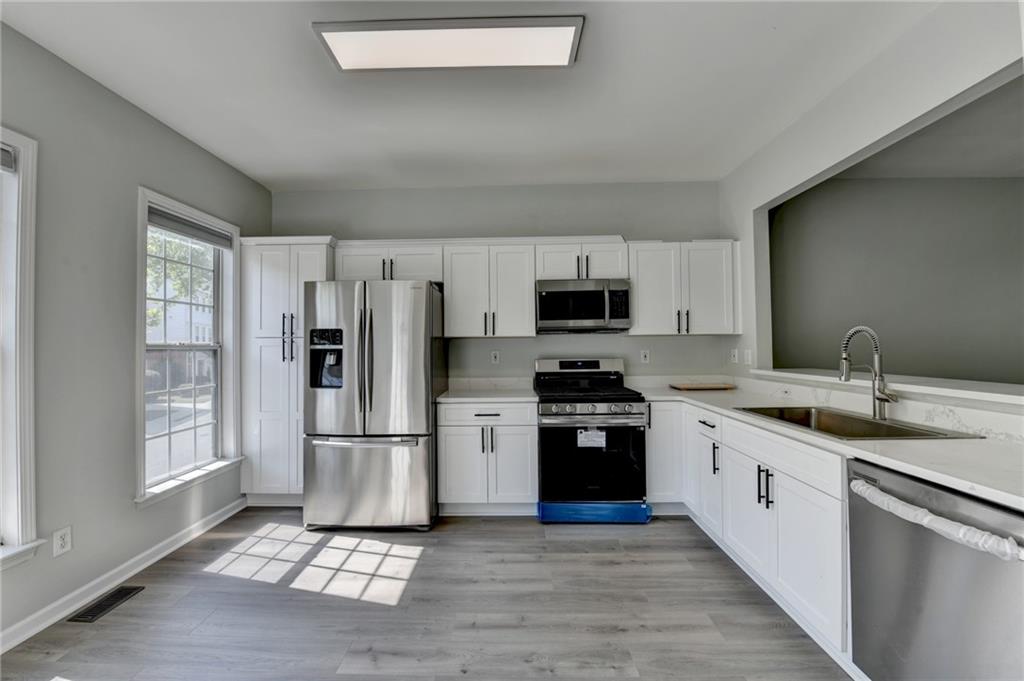 3977 Howell Park Road Duluth, GA 30096 - Photo 14 of 25 a kitchen with stainless steel appliances granite countertop a refrigerator stove and sink
