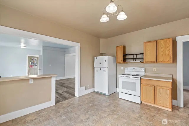 a kitchen with refrigerator cabinets and a sink