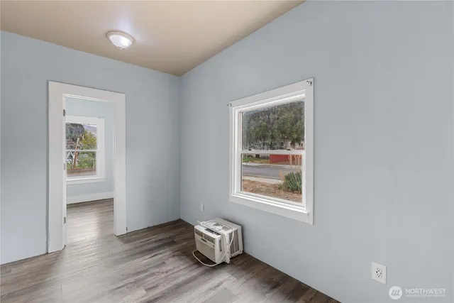 a view of room with window and wooden floor