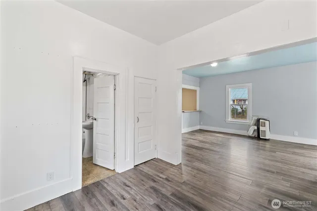 a view of a room with wooden floor