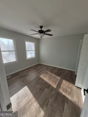 a view of a livingroom with a ceiling fan and window
