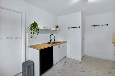 a utility room with sink dryer and washer