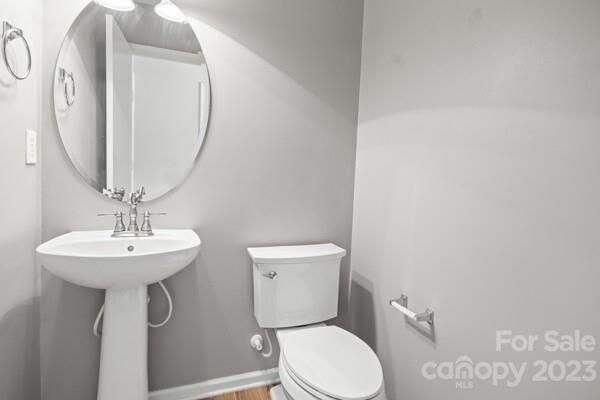 264 Ranlo Avenue Gastonia, NC 28054 - Photo 17 of 44 a bathroom with a toilet a sink and a mirror