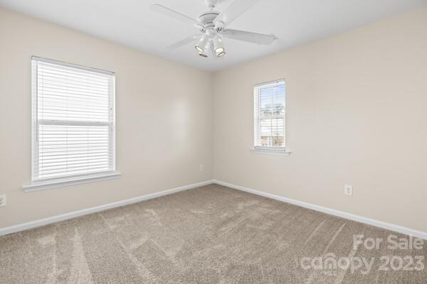 264 Ranlo Avenue Gastonia, NC 28054 - Photo 22 of 44 an empty room with a window and ceiling fan