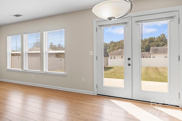 264 Ranlo Avenue Gastonia, NC 28054 - Photo 37 of 44 a view of an empty room with a window and wooden floor
