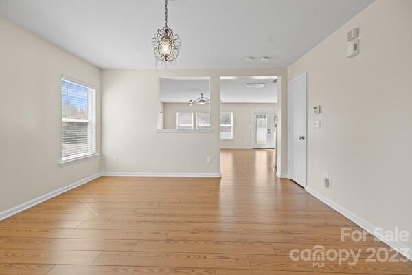 264 Ranlo Avenue Gastonia, NC 28054 - Photo 7 of 44 a view of an empty room with kitchen and window