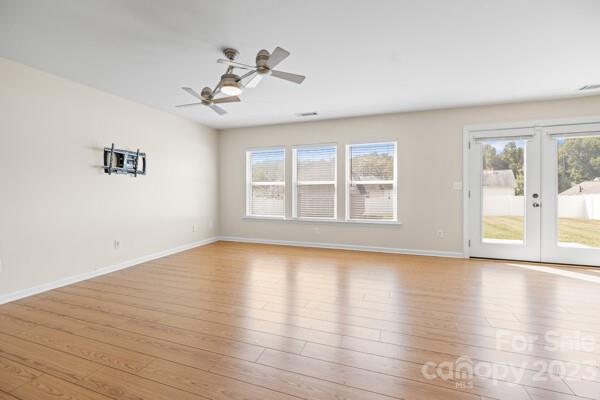 264 Ranlo Avenue Gastonia, NC 28054 - Photo 9 of 44 a view of an empty room with wooden floor and a window