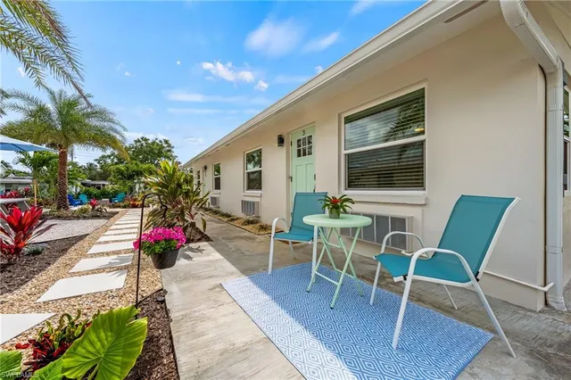 a view of a chairs and table in the back yard of the house