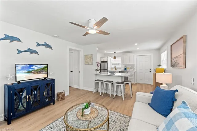 a living room with furniture and kitchen view