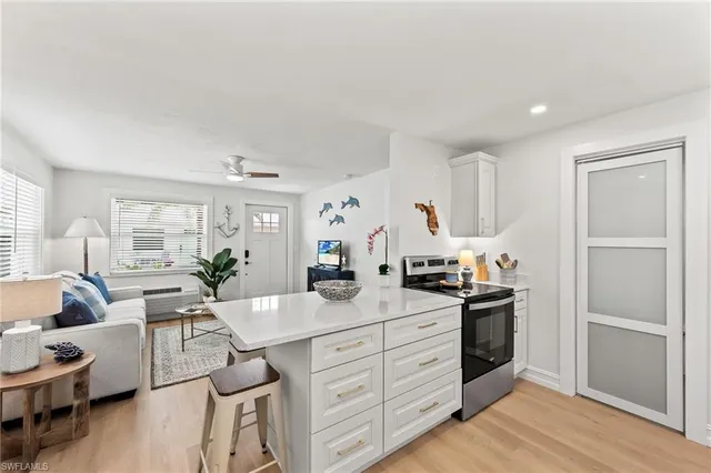 a kitchen with white cabinets and stainless steel appliances
