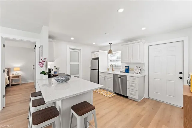 a kitchen with white cabinets and stainless steel appliances