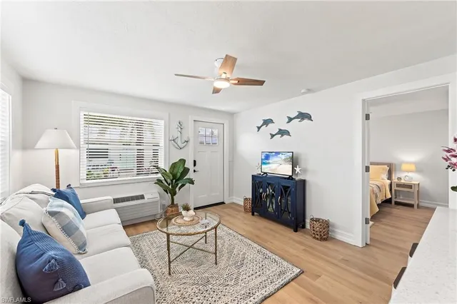 a living room with furniture and wooden floor