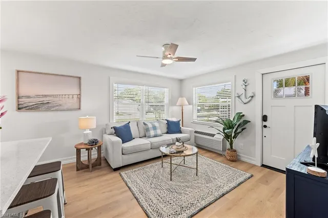 a living room with furniture potted plant and a flat screen tv