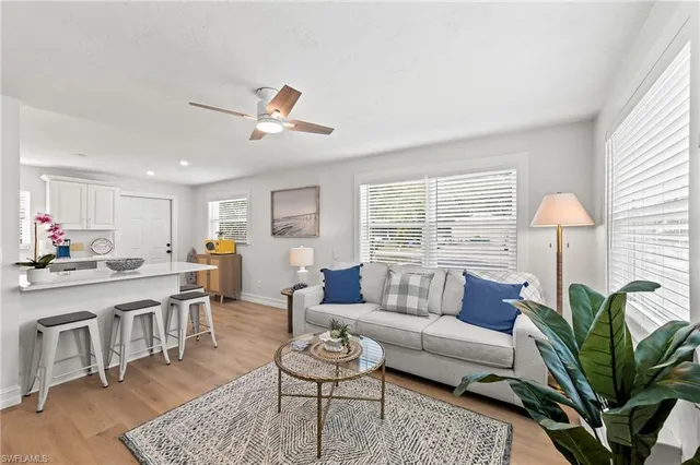 a living room with furniture a table and a potted plant