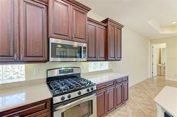 a room with kitchen island a sink and a chandelier