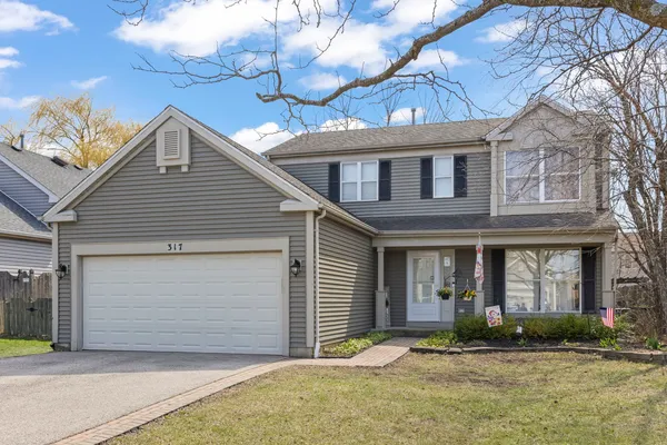 a front view of a house with a garage