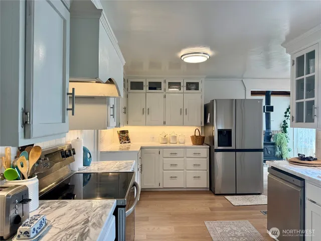 a kitchen with a refrigerator and a stove
