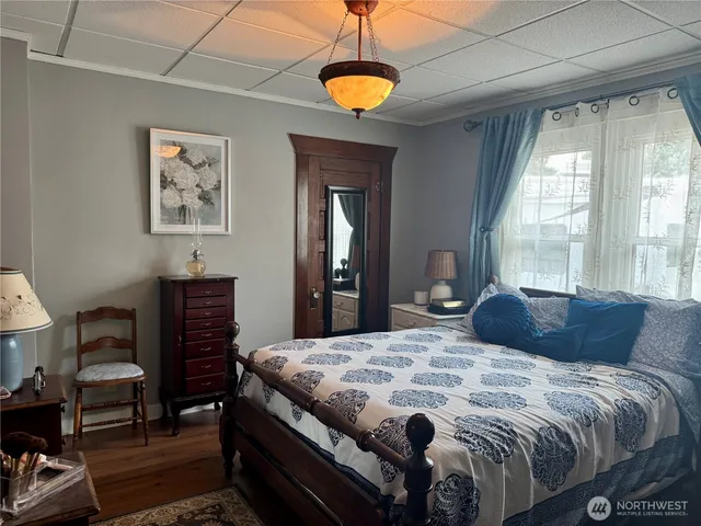 a bedroom with a bed and a chandelier