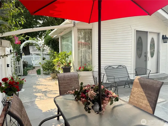 a view of balcony with two chairs and a potted plant