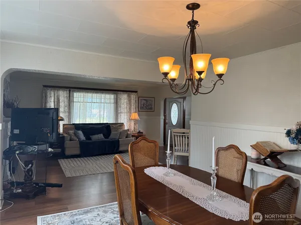 a view of a dining room with furniture and chandelier